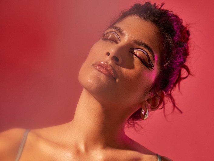 person rocking graphic liner festival makeup with their eyes closed