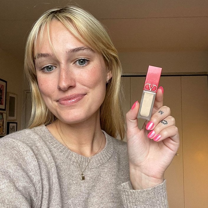 jordan wearing and holding the valentino beauty concealer