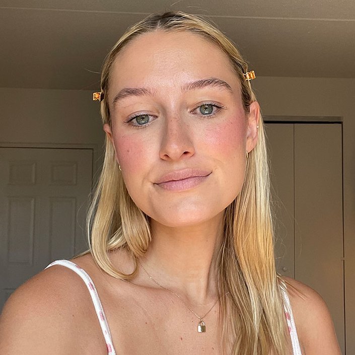 Selfie of editor with lip gloss on her cheeks as blush