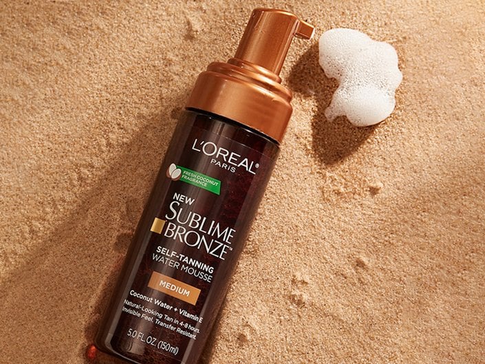 loreal paris sublime mousse tanner photographed on a sandy background