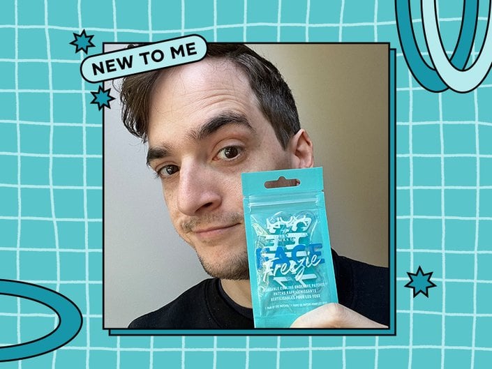 Picture of an editor holding the NYX Professional Makeup Face Freezie Reusable Cooling Under-Eye Patches, on a blue and white checked graphic background