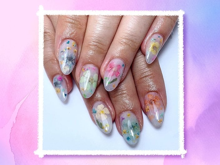 person's hands with milk bath nail art