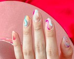 A close-up picture of a person's multicolored nail art
