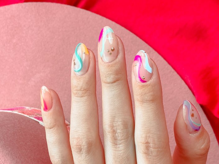 A close-up picture of a person's multicolored nail art
