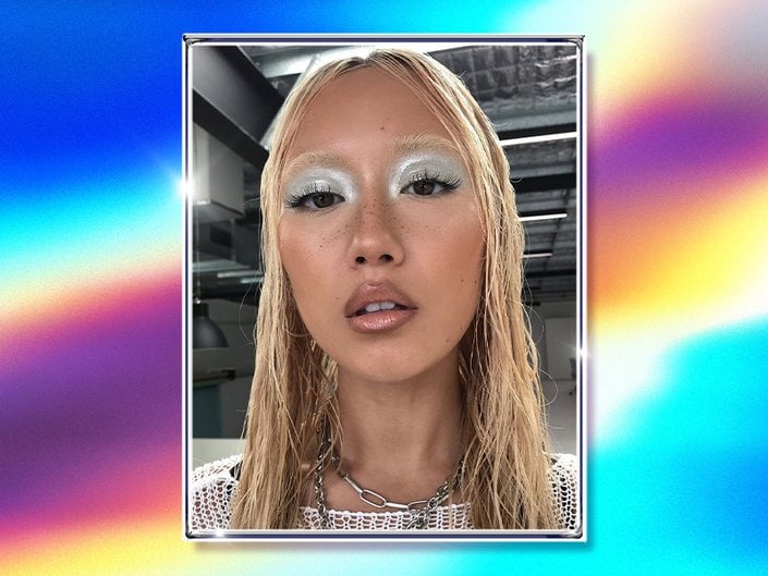 Picture of a blonde model with silver eyeshadow on a graphic multicolored background