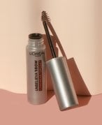 L’Oréal Paris Unbelievabrow Longwear Brow Topcoat open sitting on a blush pink surface