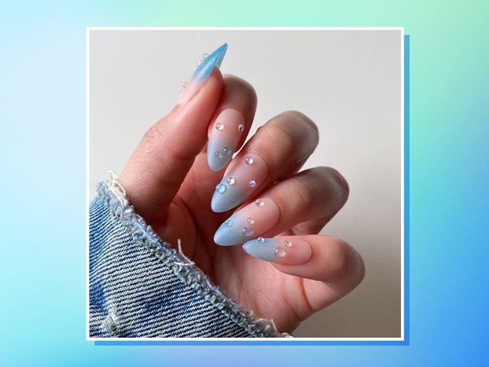 Nails painted with ombré blue sea glass tips and decorated with water droplet charms, collaged on a blue and green tie-dye background