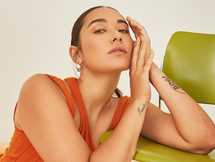 Picture of a person posing on a green. chair