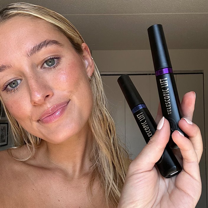 Photo of the editor wearing and holding up the L’Oréal Paris Telescopic Lift Washable Color Mascara in shades Galactic Purple and Stellar Blue