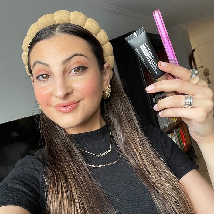 alanna holding the Maybelline New York Tattoo Studio Brow Gel and the Kosas Brow Pop