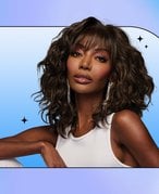 Photo of a person wearing a wig collaged on a blue graphic background