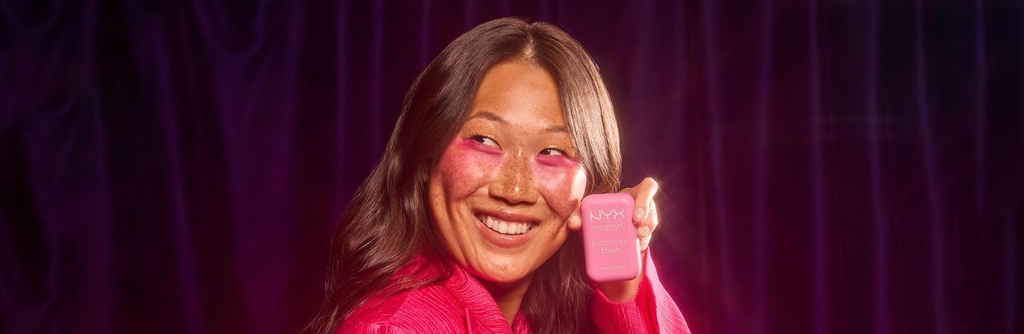 Smiling woman holding Nyx Makeup