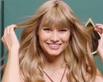 A woman with blonde hair with bangs