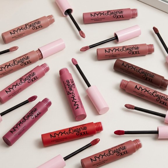 An image of NYX Lip Lingerie XXL Matte Liquid Lipstick in various shades spread across a vanity