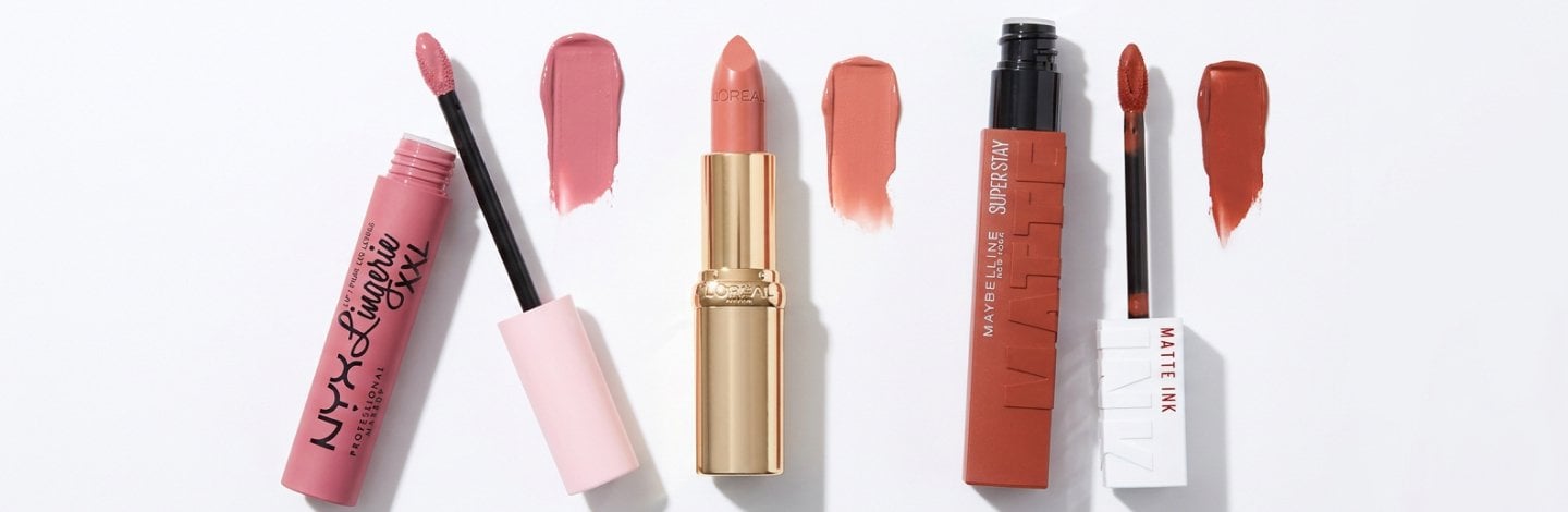 A beautiful, clean flat-lay of various lip shades and swatches from the following 3x products: Super Stay Matte Ink® Longwear Liquid Lipcolor, NYX Professional Makeup Lip Lingerie, and Maybelline New York Serum Lipstick. 