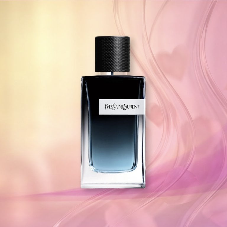 Bottle of YSL Y Eau de Parfum on a pink textured background