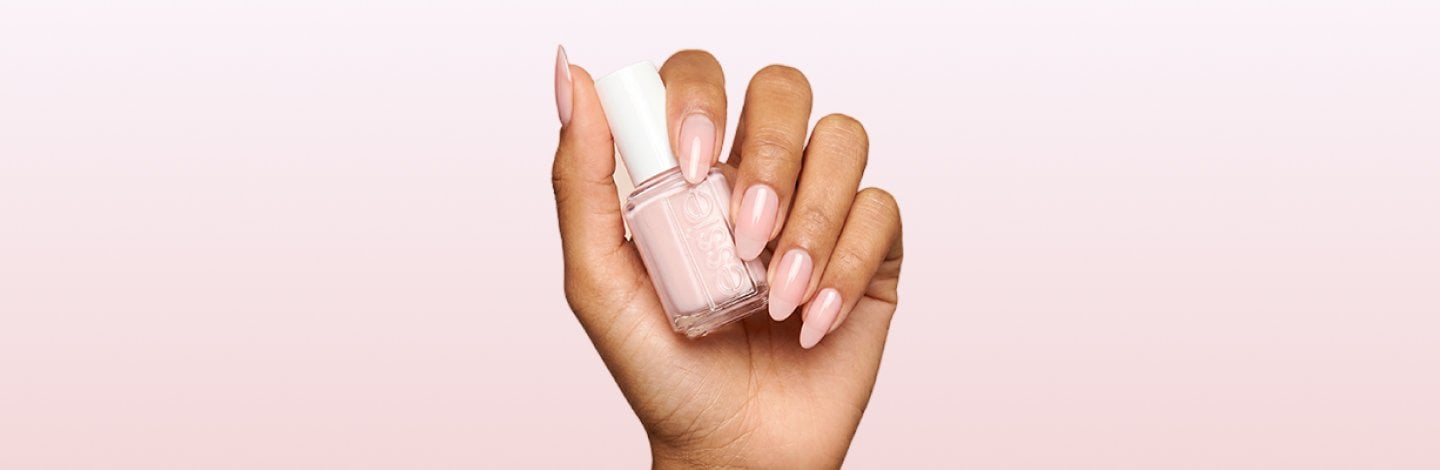 An image of a hand featuring sheer, light pink nail polish