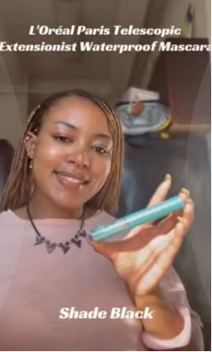 Person holding a tube of L'Oréal Paris Telescopic Extensionist Waterproof Mascara in Shade Black for a social media product showcase.