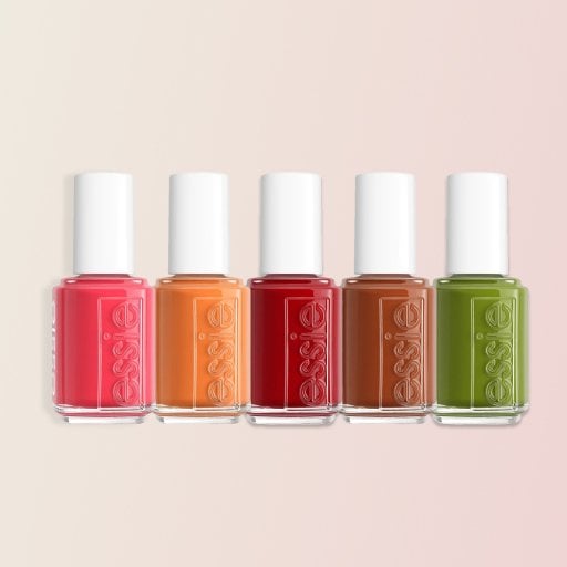 Five bottles of Essie nail polish in the shades Not a Phase, Apricot Jelly, Cute as a Button, Save a Cowboy, and Willow in the Wind on a pink background