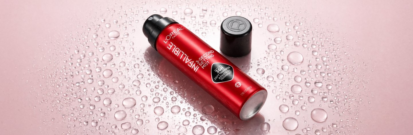Image of L'Oreal Infallible 3-Second Setting Mist on a pink gradient background with water droplets
