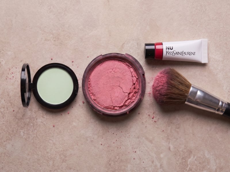 Blush compact with brush carrying product.