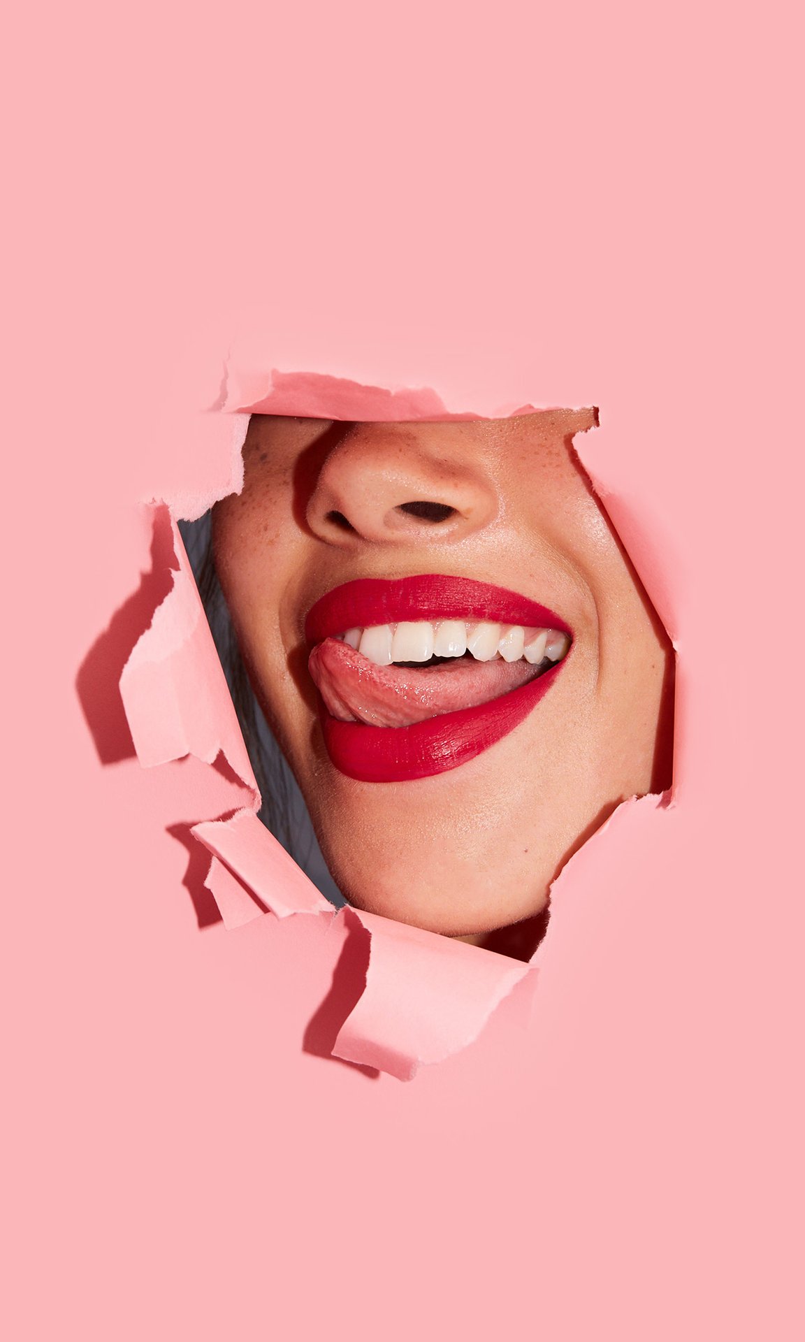 Person smiling and wearing red lipstick